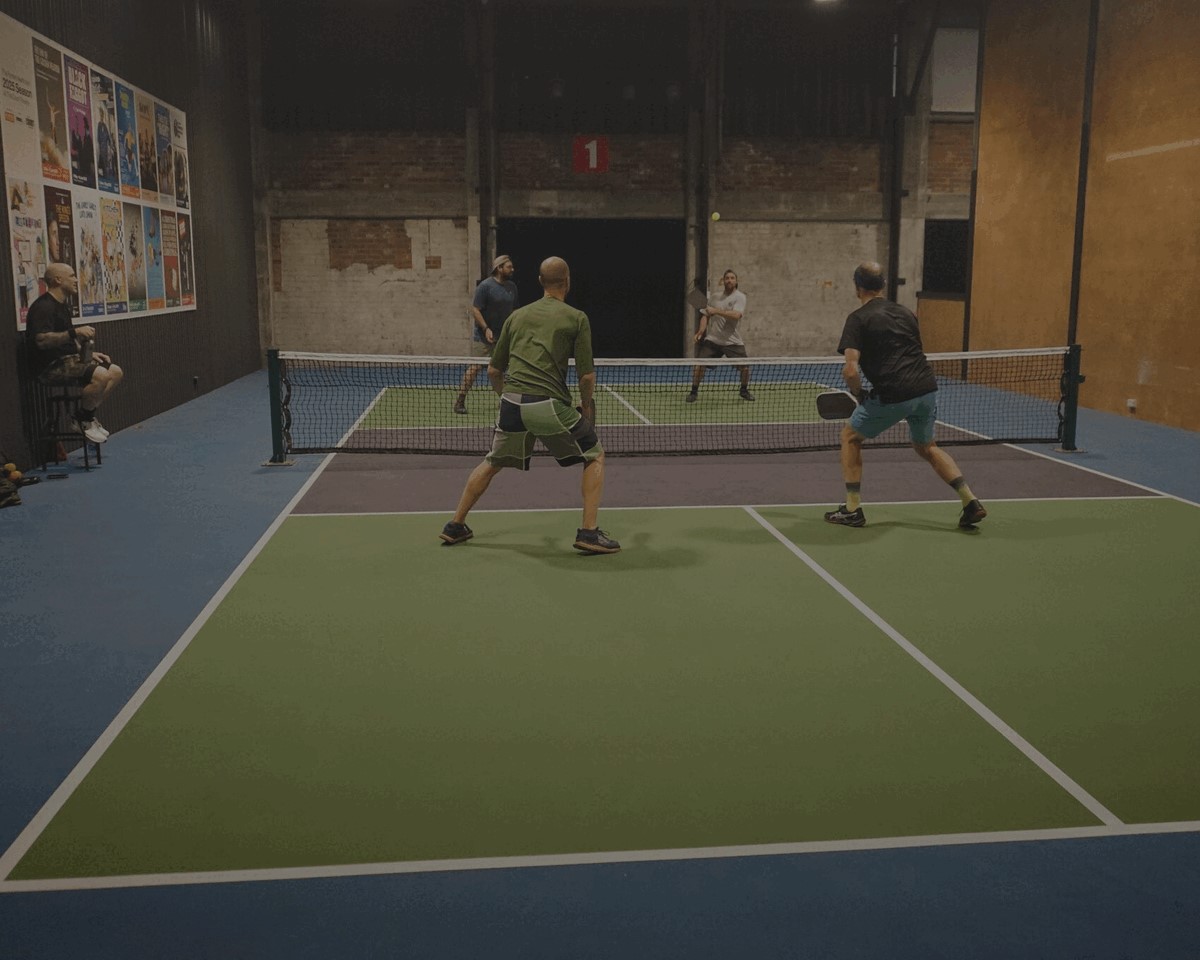 Pickleball rally on an indoor court